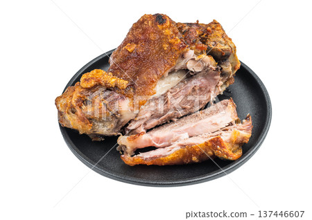Sliced roasted pork knuckle showing crispy crackling rind and juicy fibrous meat structure on black plate against clean white background. Sliced roasted pork knuckle showing crispy crackling rind and juicy fibrous meat structure on black plate against clean white background. 137446607