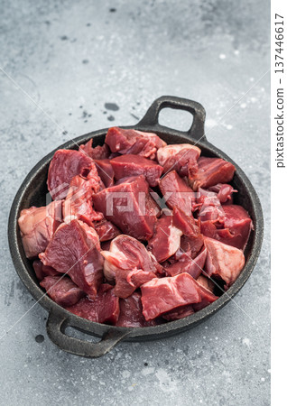 Diced lamb and goat hearts in a castiron skillet on a rustic board, perfect for hearty stews, braising and rich offal recipes. Diced lamb and goat hearts in a castiron skillet on a rustic board, perfect for hearty stews, braising and rich offal recipes. 137446617