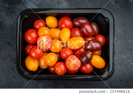 Fresh organic cherry tomatoes arranged in a retail style container clean minimal top view great for healthy cooking and salad concepts. Fresh organic cherry tomatoes arranged in a retail style container clean minimal top view great for healthy cooking and salad concepts. 137446618