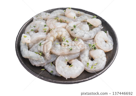 Raw peeled shrimp prawn with fresh thyme in a dark metal plate on a white background. High-key seafood ingredient for healthy cooking. 137446692
