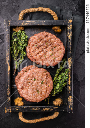 Grilled hamburger mince meat patties with herbs. black background. top view Grilled hamburger mince meat patties with herbs. black background. top view 137446723