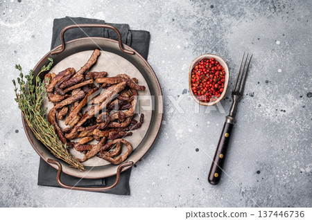 Deep fried beef tender strips, sliced meat in a tray. grey background. top view Deep fried beef tender strips, sliced meat in a tray. grey background. top view 137446736