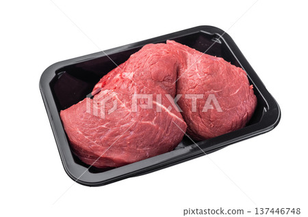 Raw beef cut tenderloin in plastic tray on white background. Fresh meat suitable for steaks or classic homemade roast beef cooking. 137446748