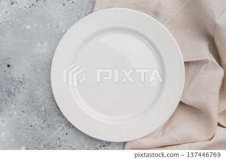 Empty white ceramic plate on gray concrete background with linen cloth. Minimal tableware mockup with copy space 137446769