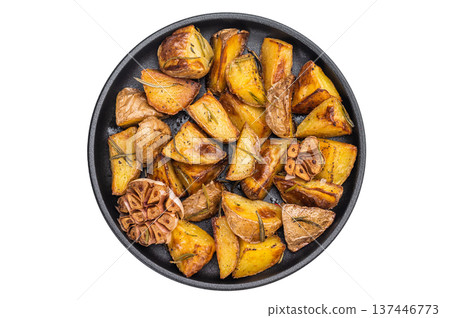 Golden roasted potato wedges with garlic and rosemary cooked in skillet. Rustic vegetarian side dish with copy space Golden roasted potato wedges with garlic and rosemary cooked in skillet. Rustic vegetarian side dish with copy space 137446773