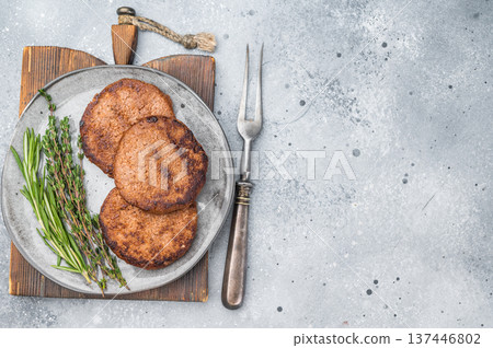 Vegan meatless burger patties plant based protein healthy alternative with herbs on light textured background Vegan meatless burger patties plant based protein healthy alternative with herbs on light textured background 137446802