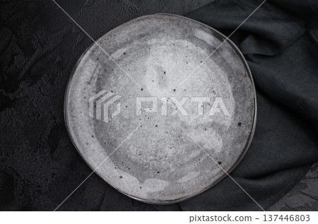 Gray matte plate overhead on dark background. Premium empty tableware with dramatic contrast Gray matte plate overhead on dark background. Premium empty tableware with dramatic contrast 137446803