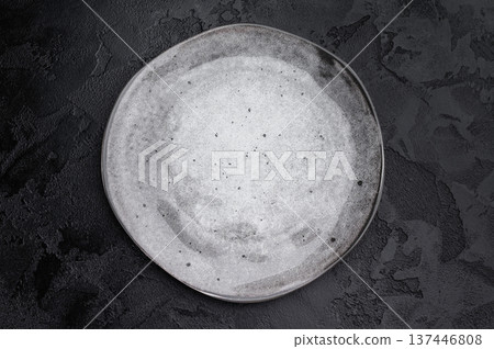 Gray matte plate overhead on dark background. Premium empty tableware with dramatic contrast Gray matte plate overhead on dark background. Premium empty tableware with dramatic contrast 137446808