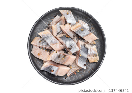 Salted herring pieces with peppercorns and parsley in black plate. isolated white background seafood appetizer with copy space. 137446841