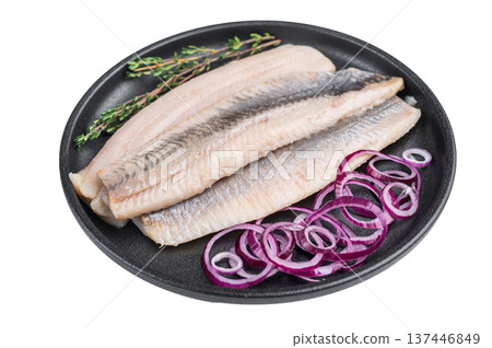 Marinated herring fish fillets with spices and onion in plate. Nordic seafood ingredient on isolated background . 137446849