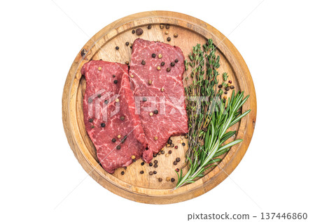 Fresh raw beef steak flatiron cut with herbs and spices on rustic wooden board overhead view isolated background Fresh raw beef steak flatiron cut with herbs and spices on rustic wooden board overhead view isolated background 137446860