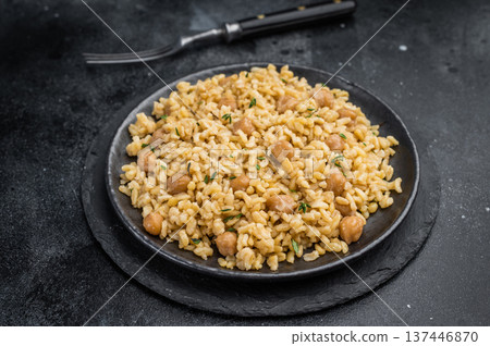 Healthy bulgur pilaf with chickpeas and herbs Turkish cuisine served on plate top view minimal style Healthy bulgur pilaf with chickpeas and herbs Turkish cuisine served on plate top view minimal style 137446870