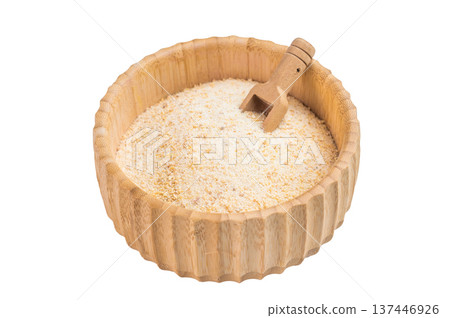 Granulated dried garlic spice in bamboo bowl with wooden scoop isolated on white background. Natural seasoning flatlay 137446926