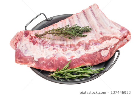 Pork spareribs raw whole rack with garlic and herbs in tray flat lay meat ingredient for grilling smoking and roasting Pork spareribs raw whole rack with garlic and herbs in tray flat lay meat ingredient for grilling smoking and roasting 137446933