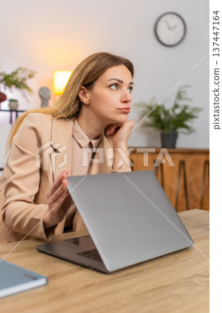 Businesswoman shuts laptop tired look waves hand annoyed by boring job after long shift frustrated Businesswoman shuts laptop tired look waves hand annoyed by boring job after long shift frustrated 137447164