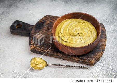 Sweet pistachio cream spread with rich green color served in wooden bowl flat lay minimal food styling with copy space 137447218