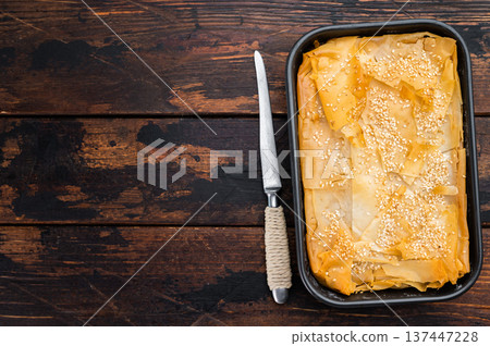 Traditional Greek spanakopita phyllo pie with spinach cheese filling, golden baked crust and sesame topping Traditional Greek spanakopita phyllo pie with spinach cheese filling, golden baked crust and sesame topping 137447228