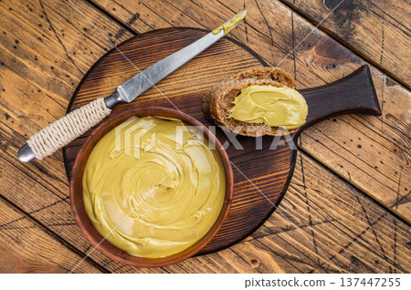 Sweet pistachio cream spread on bread with wooden bowl and knife overhead view rustic breakfast concept with copy space Sweet pistachio cream spread on bread with wooden bowl and knife overhead view rustic breakfast concept with copy space 137447255