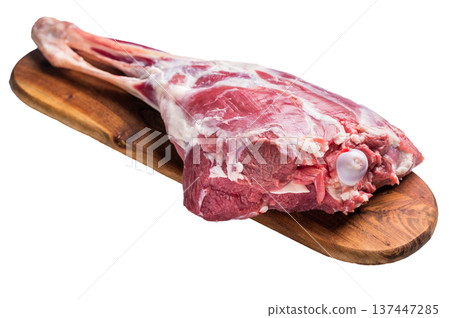 Whole raw goat leg, uncooked meat on butcher board isolated on white background. top view Whole raw goat leg, uncooked meat on butcher board isolated on white background. top view 137447285