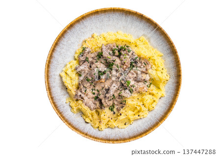 Plate of tender beef stroganoff served with creamy mashed potatoes and steaming gravy isolated on white background. top view Plate of tender beef stroganoff served with creamy mashed potatoes and steaming gravy isolated on white background. top view 137447288