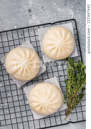 Baozi Bun, Chinese Steamed bun with meat. grey background. top view Baozi Bun, Chinese Steamed bun with meat. grey background. top view 137447442