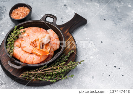 Raw Headless Red Argentine shrimps, Prawns in a skillet. grey background. top view Raw Headless Red Argentine shrimps, Prawns in a skillet. grey background. top view 137447448