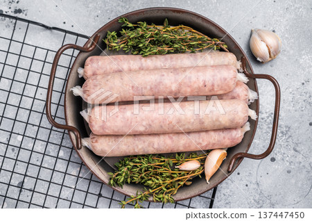 Homemade raw pork sausage, german bratwurst. grey background. top view Homemade raw pork sausage, german bratwurst. grey background. top view 137447450