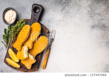 Deep fried Fish fingers on wooden board. white background. top view 137447468