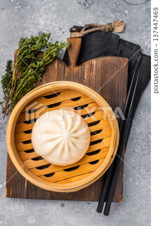 Chinese Bao or Baozi bun with meat in bamboo steamer. grey background. top view 137447469