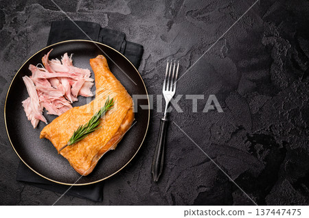 Traditional Smoked chicken leg, poultry meat on plate. black background. top view Traditional Smoked chicken leg, poultry meat on plate. black background. top view 137447475