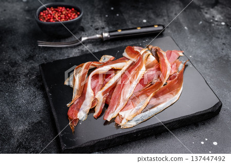 Cured dried duck breast meat slices, magret smoked poultry. black background. top view 137447492