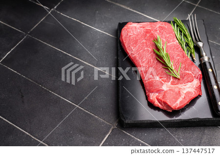 Delicious marbled Raw top sirloin beef steak with rosemary. black background. top view Delicious marbled Raw top sirloin beef steak with rosemary. black background. top view 137447517