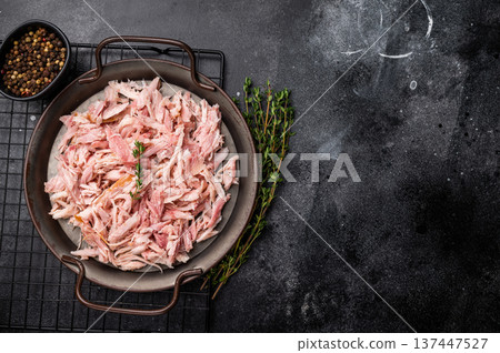 Hot smoked Pulled Chicken meat, cooked poultry in a tray. black background. top view Hot smoked Pulled Chicken meat, cooked poultry in a tray. black background. top view 137447527