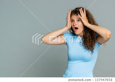 Young amazed woman surprised mouth open amazed astonished reaction unexpected wow facial expression Young amazed woman surprised mouth open amazed astonished reaction unexpected wow facial expression 137447658
