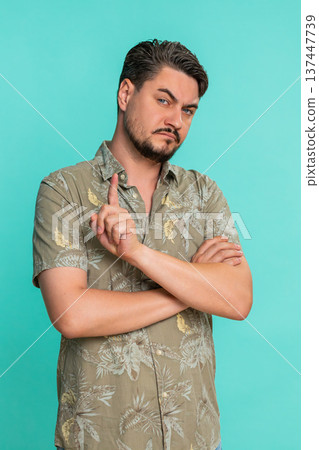 Man crossing arms on chest shaking head expressing disagreement refusal firm negative body language Man crossing arms on chest shaking head expressing disagreement refusal firm negative body language 137447739