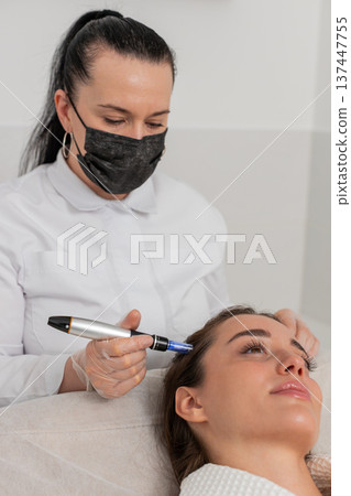 Hair mesotherapy session for woman in trichology clinic microneedling dermapen vitamin injection 137447755