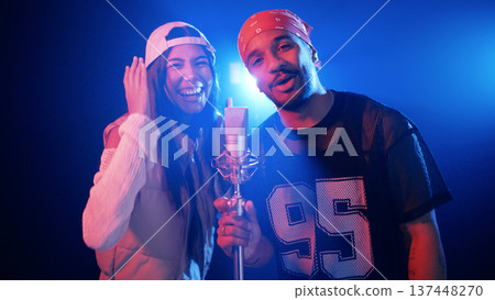 Artists performing music duet in recording studio Artists performing music duet in recording studio 137448270