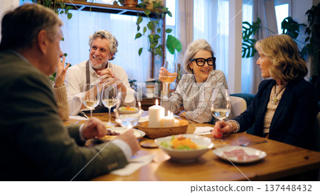 Senior friends enjoying dinner party at home 137448432