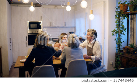 Senior friends enjoying dinner party at home toasting wine Senior friends enjoying dinner party at home toasting wine 137448446