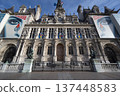 City Hall of Paris, France building adorned with colorful flags and rich architecture 137448583