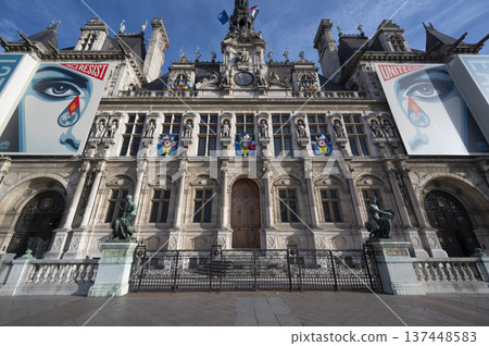 City Hall of Paris, France building adorned with colorful flags and rich architecture 137448583