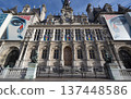 City Hall of Paris, France building adorned with colorful flags and rich architecture 137448586