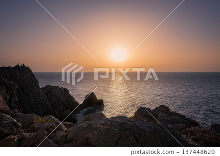 Sunset over the coast, rock formations, big ball sunshine 137448620