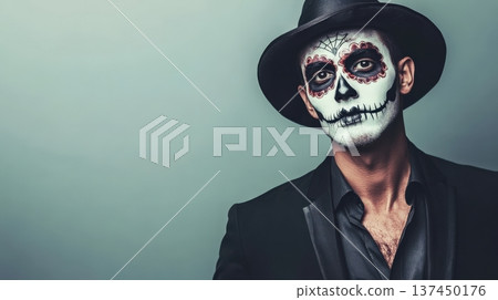 Man with skull face paint wearing a black hat and suit for Halloween celebration and festivities 137450176