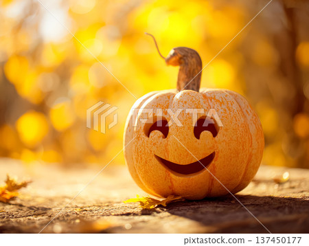 Smiling carved pumpkin on wooden table with autumn leaves and blurred golden background 137450177