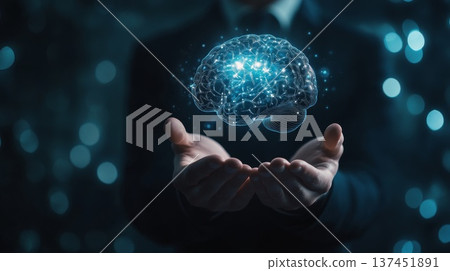 A businessman in a suit confidently holds a glowing brain, symbolizing innovation, creativity, and technological advancement. 137451891