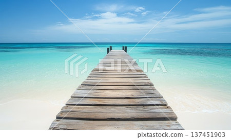 Tranquil Wooden Pier Extending into a Serene Ocean Under a Bright Blue Sky at Sunset Tranquil Wooden Pier Extending into a Serene Ocean Under a Bright Blue Sky at Sunset 137451903