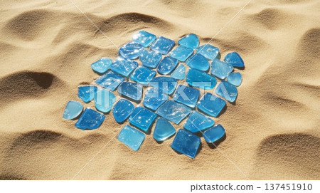 A Beautiful Pile of Blue Sea Glass Shimmering Under the Warm Sunlight on a Sandy Beach 137451910