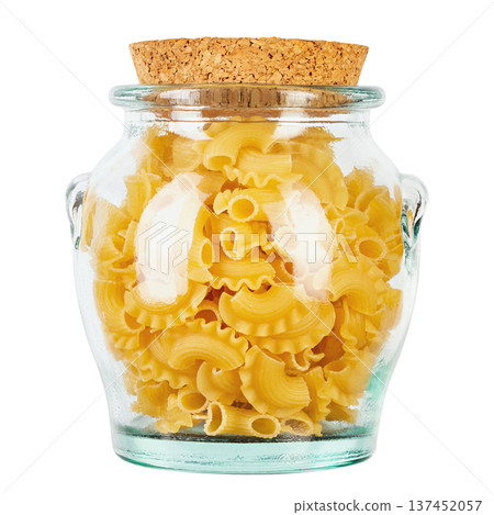 Dried macaroni cockerel scallops. Pasta in a glass jar isolated on a white background. Dried macaroni cockerel scallops. Pasta in a glass jar isolated on a white background. 137452057