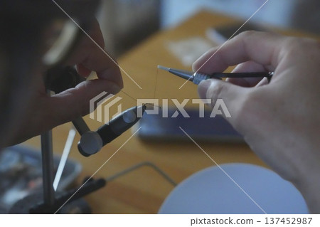 A man making a fly A man making a fly 137452987